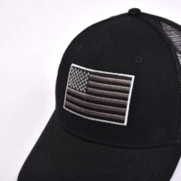 Aung-Crown-mens-black-trucker-hat-with-a-flat-embroidery-applqiue-at-the-front-KN2101281