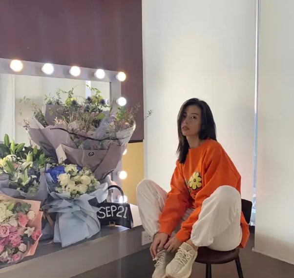 bright orange sweatshirt with flower patterns